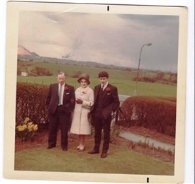 Photo:Jackie and Grace Davidson and Bobby early 70s. The viaduct can be seen and the Stoneyburn bing. The field behind is where the school is now.