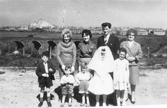 Photo:The McInally family of Stoneyburn after their daughter's First Communion.  In the background you can see the west of the two railway viaducts.  Also visible in the background is Foulshiels Bing, and part of Cuthill Crescent in Stoneyburn.  1960.