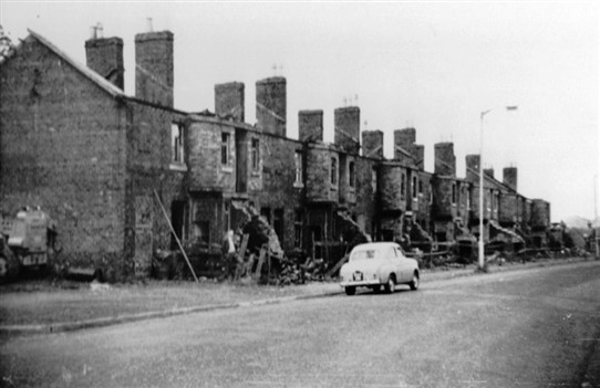 Photo:Livingstone Street in the process of demolition, 1960s.  Note Willie Cramb standing at the door of his house.